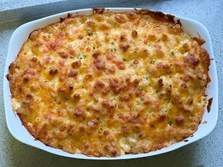 Homemade Tinis Mac and Cheese served hot in a skillet with golden cheesy crust