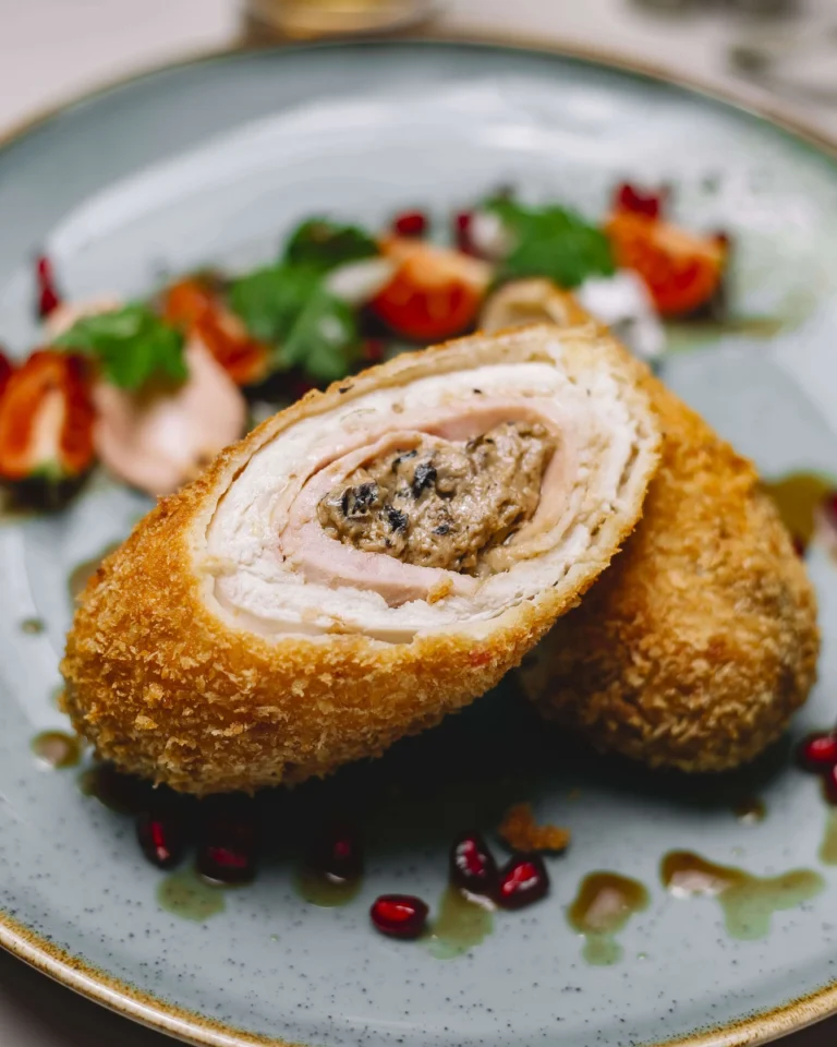 Homemade golden-brown Scotch Eggs sliced open to reveal a perfectly cooked yolk inside.