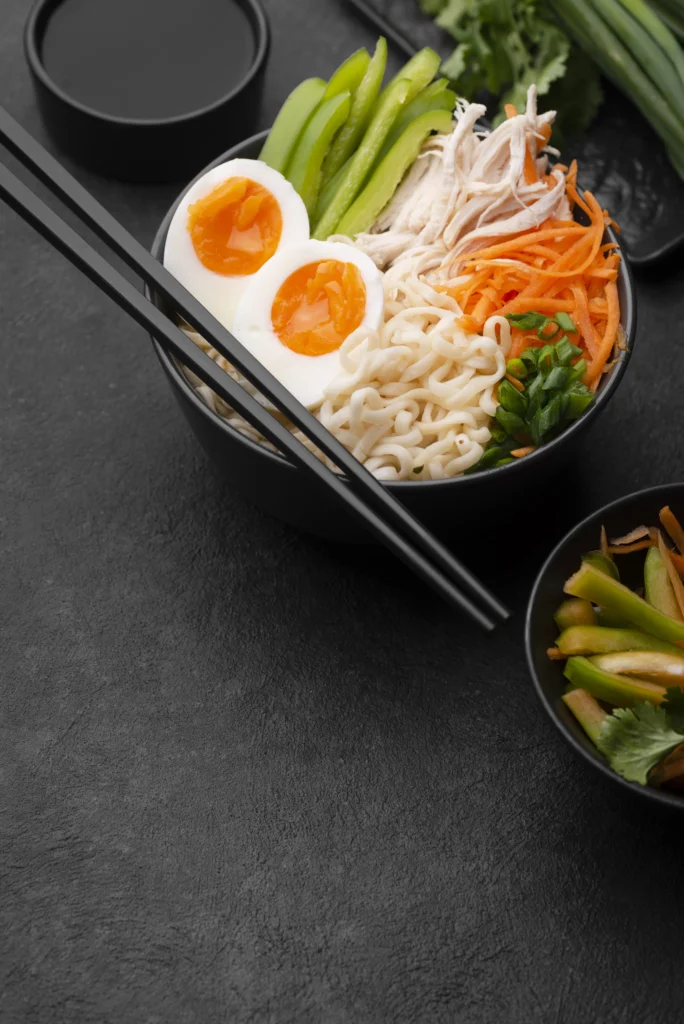 Bibimbap bowl with colorful vegetables, fried egg, and Korean sides.