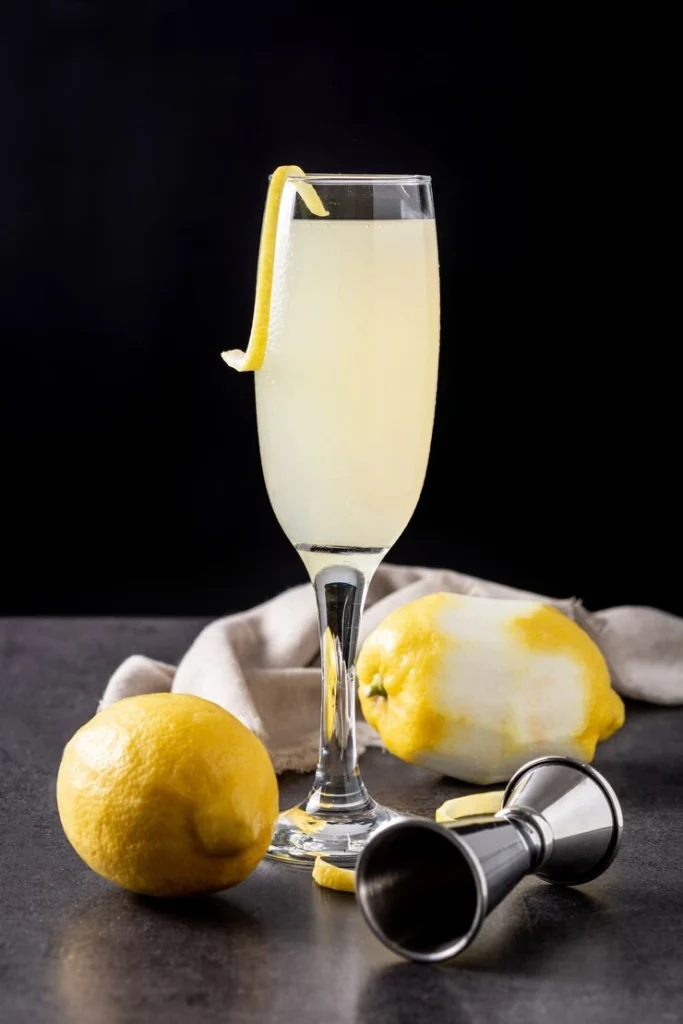 Refreshing Limoncello Spritz cocktail with ice cubes and lemon garnish on a wooden table.