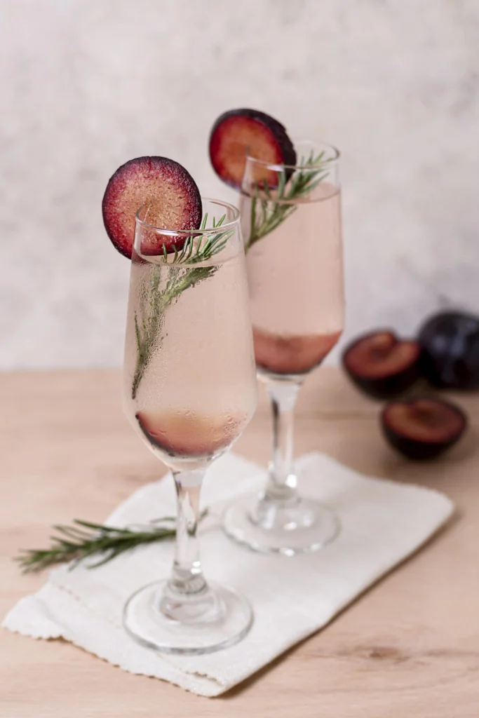 Elegant Kir Royal cocktail with lemon twist served in a frosted champagne flute.