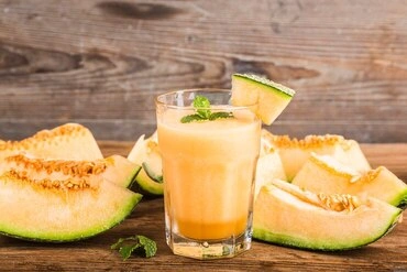 Cantaloupe agua fresca poured into glass