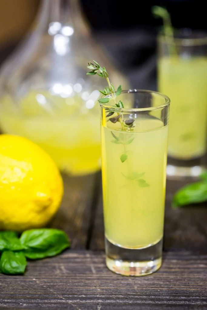 Limoncello Spritz cocktail poured into a glass with ice and lemon slice, sparkling bubbles visible.