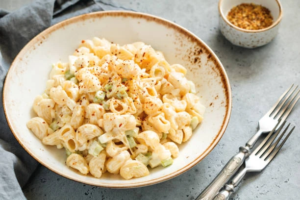 Bowl of macaroni salad with creamy mayo and diced vegetables