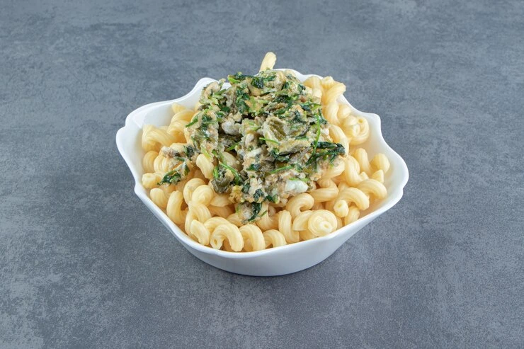Tuna pasta salad with colorful vegetables in a white bowl