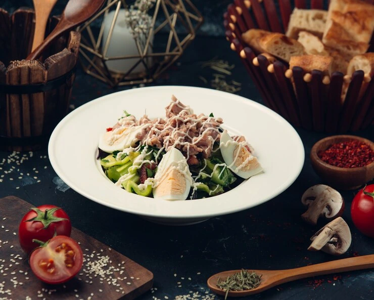 Creamy tuna pasta salad topped with parsley and lemon
