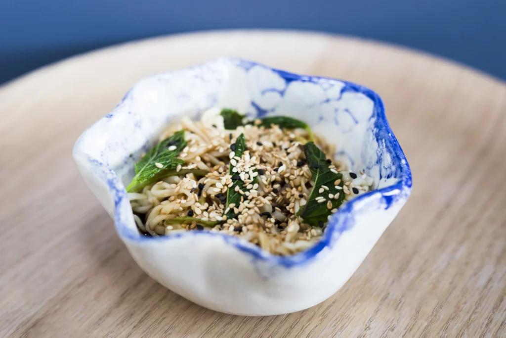 Healthy salade-de-riz with vegetables and sticky rice on the side.