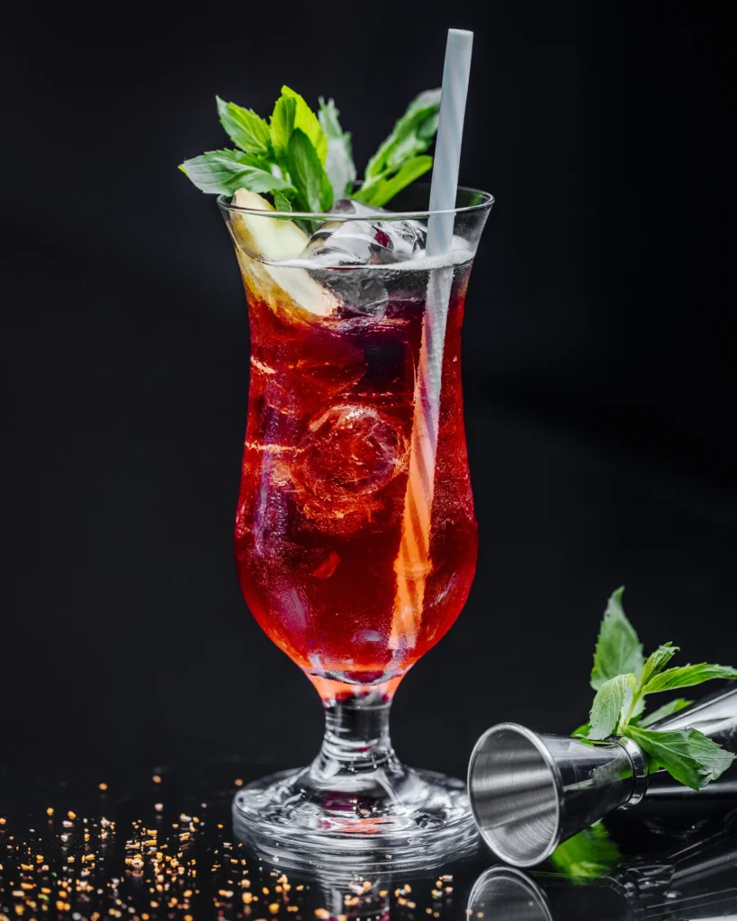A modern Manhattan cocktail with a spiral lemon peel, perfect for sharing on social platforms.