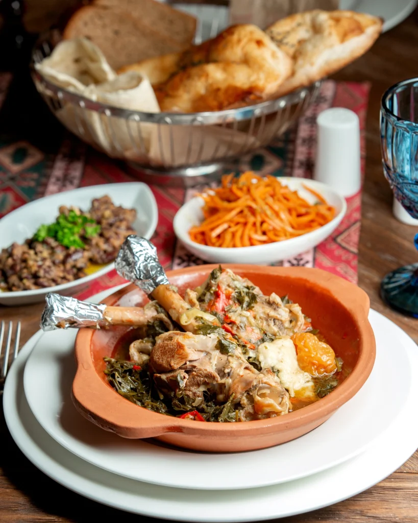 Colorful Sunday lunch with a variety of foods including noodles, sausage, omelette, and orange juice.