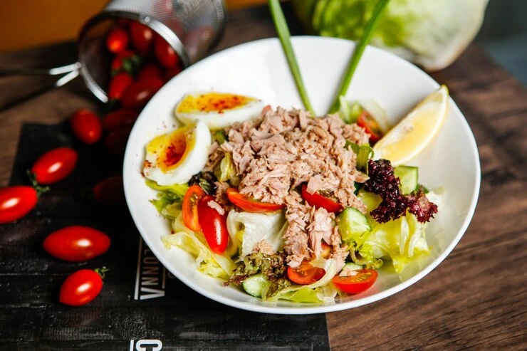 Cold tuna pasta salad served on a wooden table