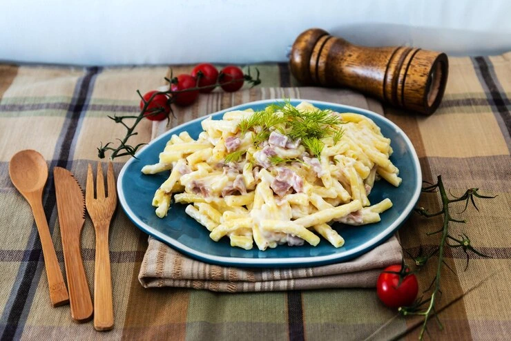 Colorful macaroni salad with rotini pasta, vegetables, and creamy dressing
