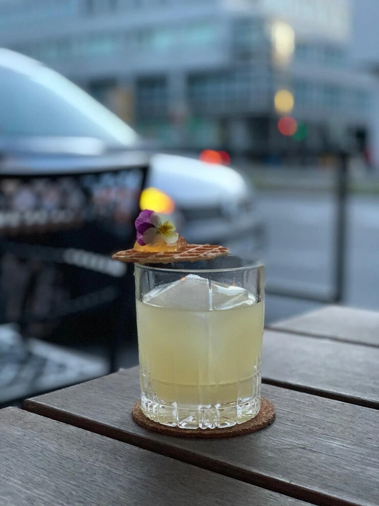 Icy Moscow Mule in a short glass with lime wedge and mint sprig on a rustic linen cloth.