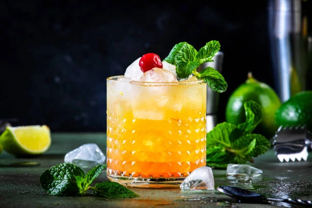 Tropical Mai Tai cocktail with pineapple garnish and pink umbrella, set against lush palm leaves in warm sunlight.