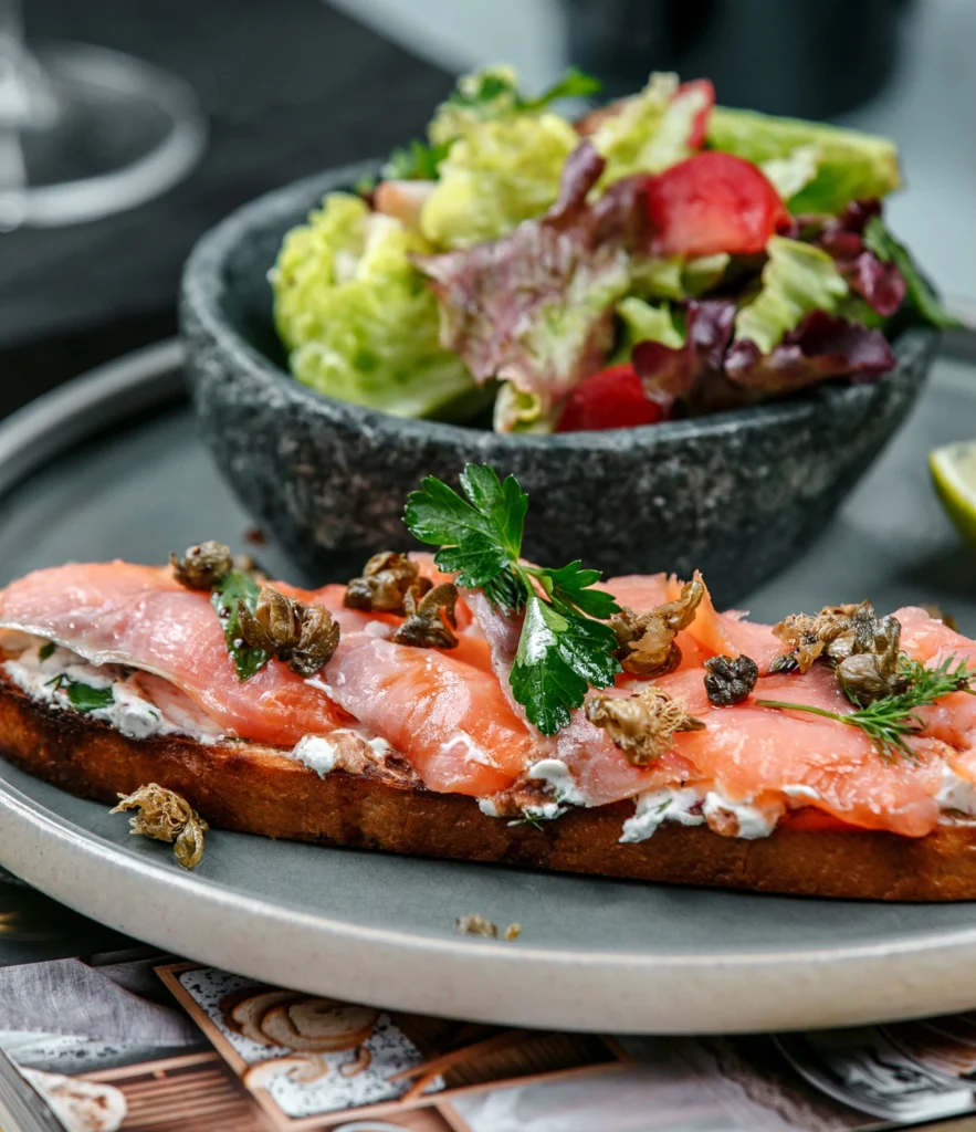 Perfectly grilled Wild Alaskan Salmon with smooth yellow sauce and herb mash.